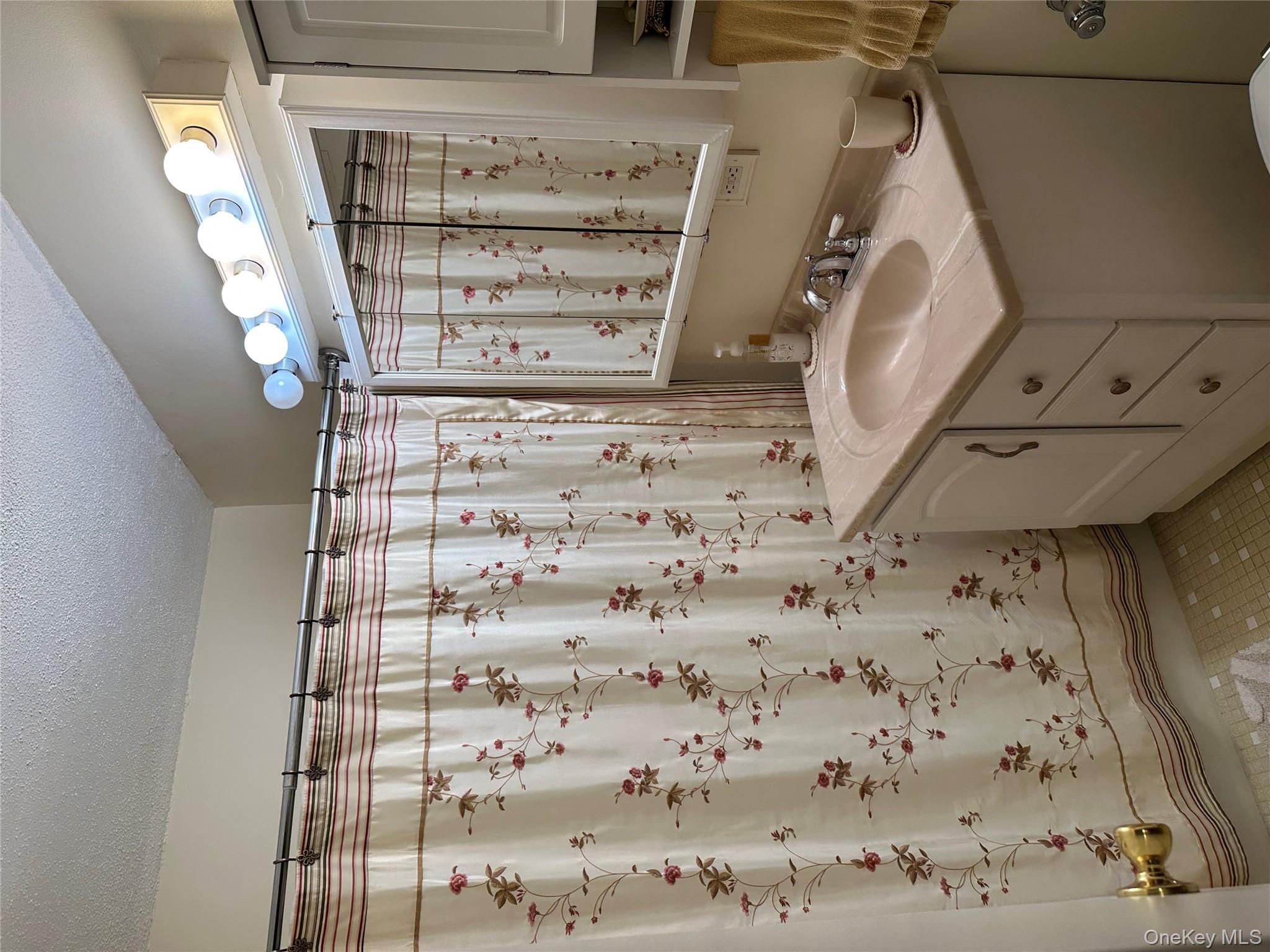 72-35 112th Street, Unit 2E Queens, NY 11375 - Photo 5 of 11 a bathroom with a granite countertop sink a mirror a vanity and a shower