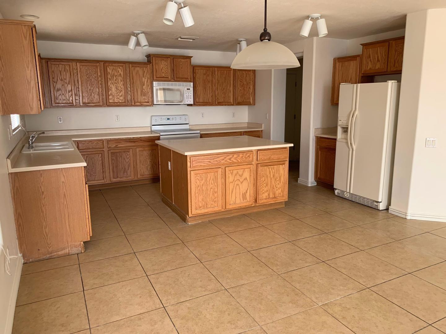 43589 West Cowpath Road Maricopa, AZ 85138 - Photo 1 of 6 a kitchen with stainless steel appliances granite countertop a stove a sink and a refrigerator