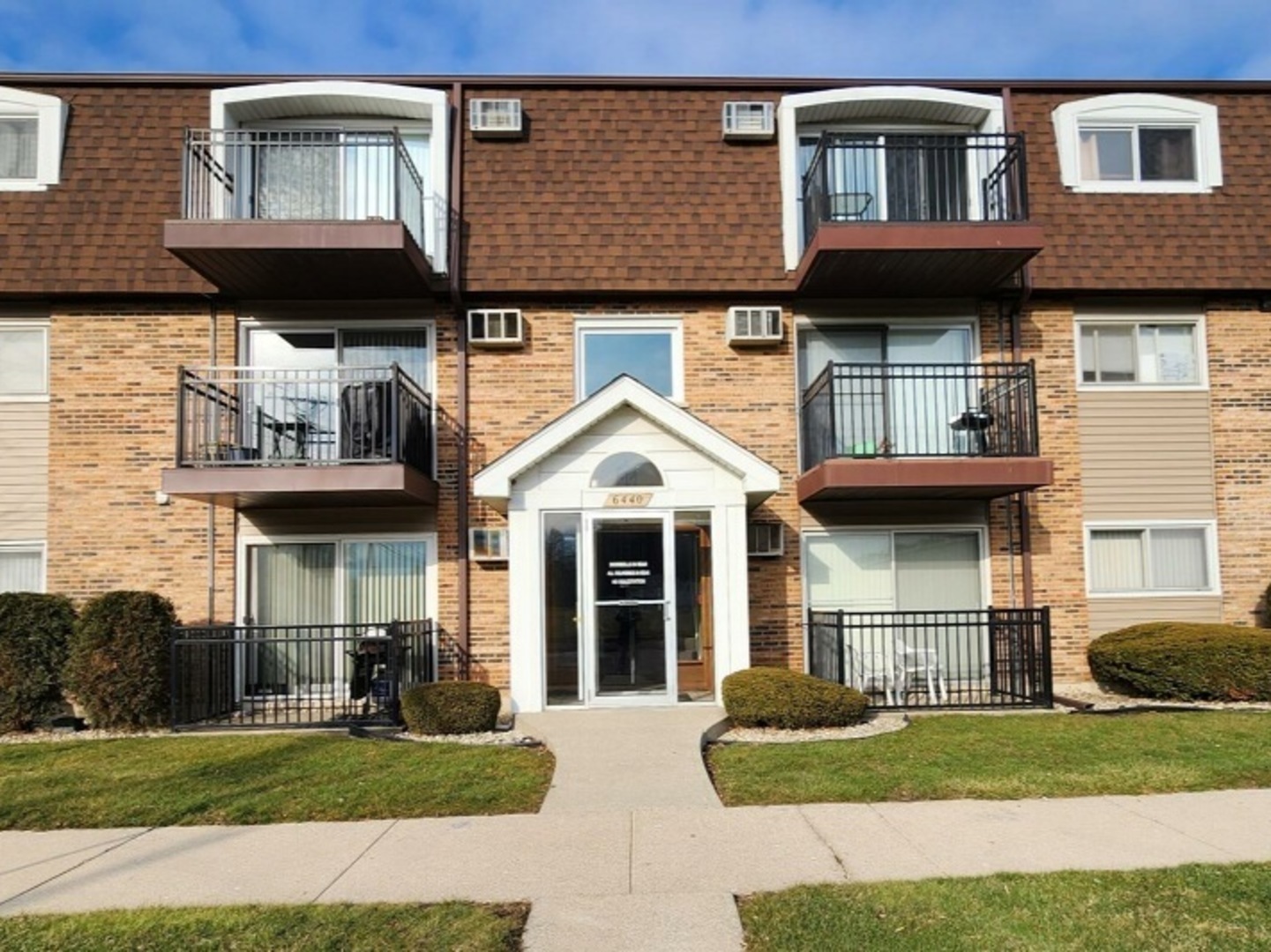 6440 Pamela Lane, Unit 12 Chicago Ridge, IL 60415 - Photo 1 of 15 a front view of a house with a yard