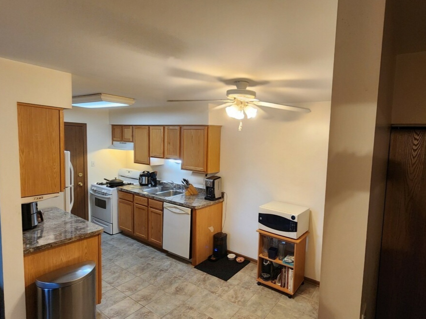 6440 Pamela Lane, Unit 12 Chicago Ridge, IL 60415 - Photo 3 of 15 a kitchen with stainless steel appliances granite countertop a stove top oven a sink and dishwasher