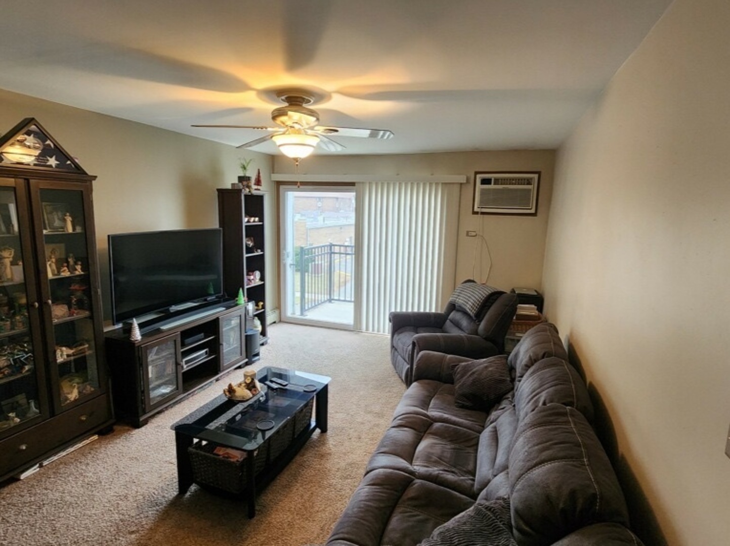 6440 Pamela Lane, Unit 12 Chicago Ridge, IL 60415 - Photo 5 of 15 a living room with furniture and a flat screen tv