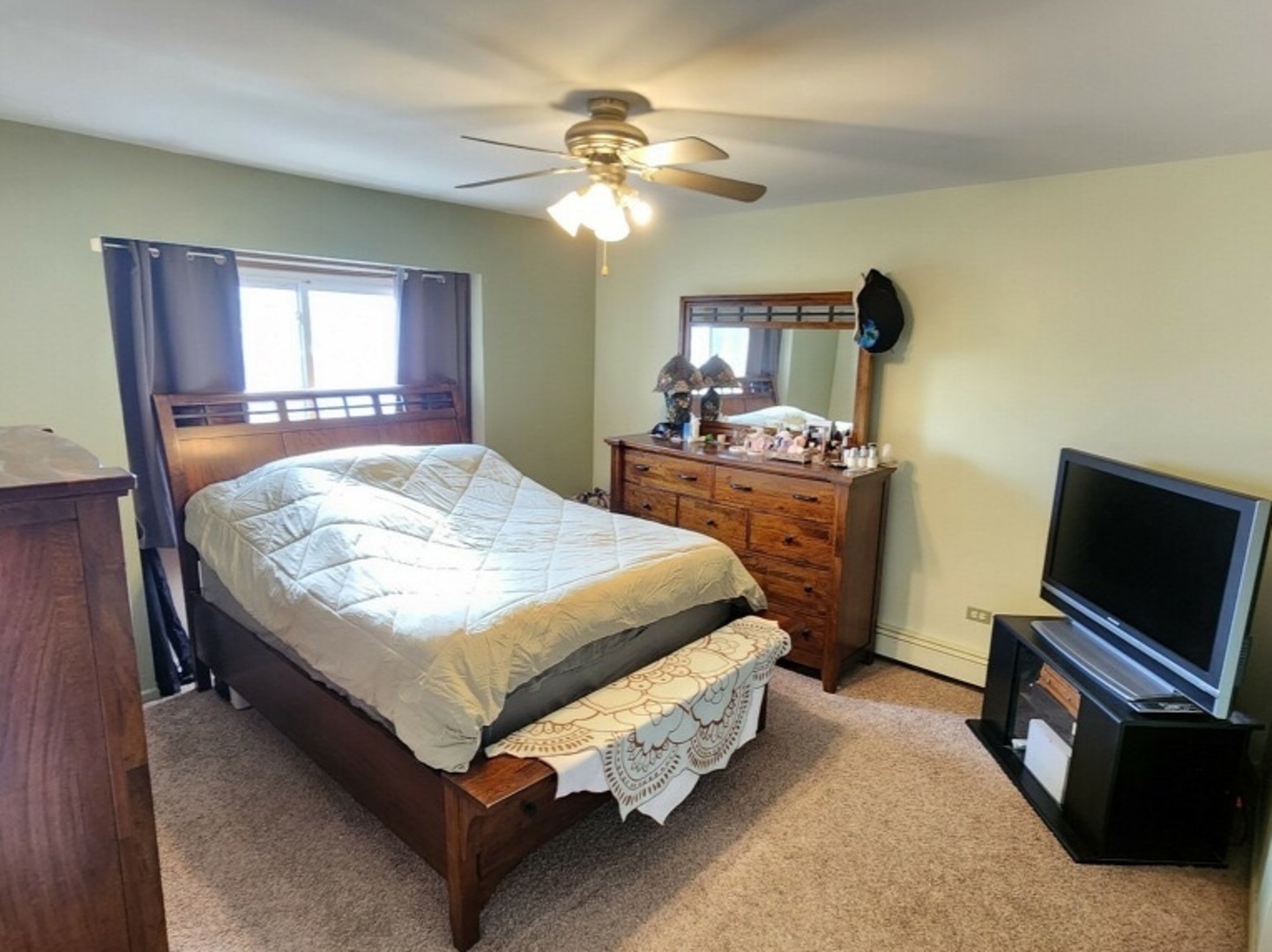 6440 Pamela Lane, Unit 12 Chicago Ridge, IL 60415 - Photo 7 of 15 a bedroom with a bed and a flat screen tv