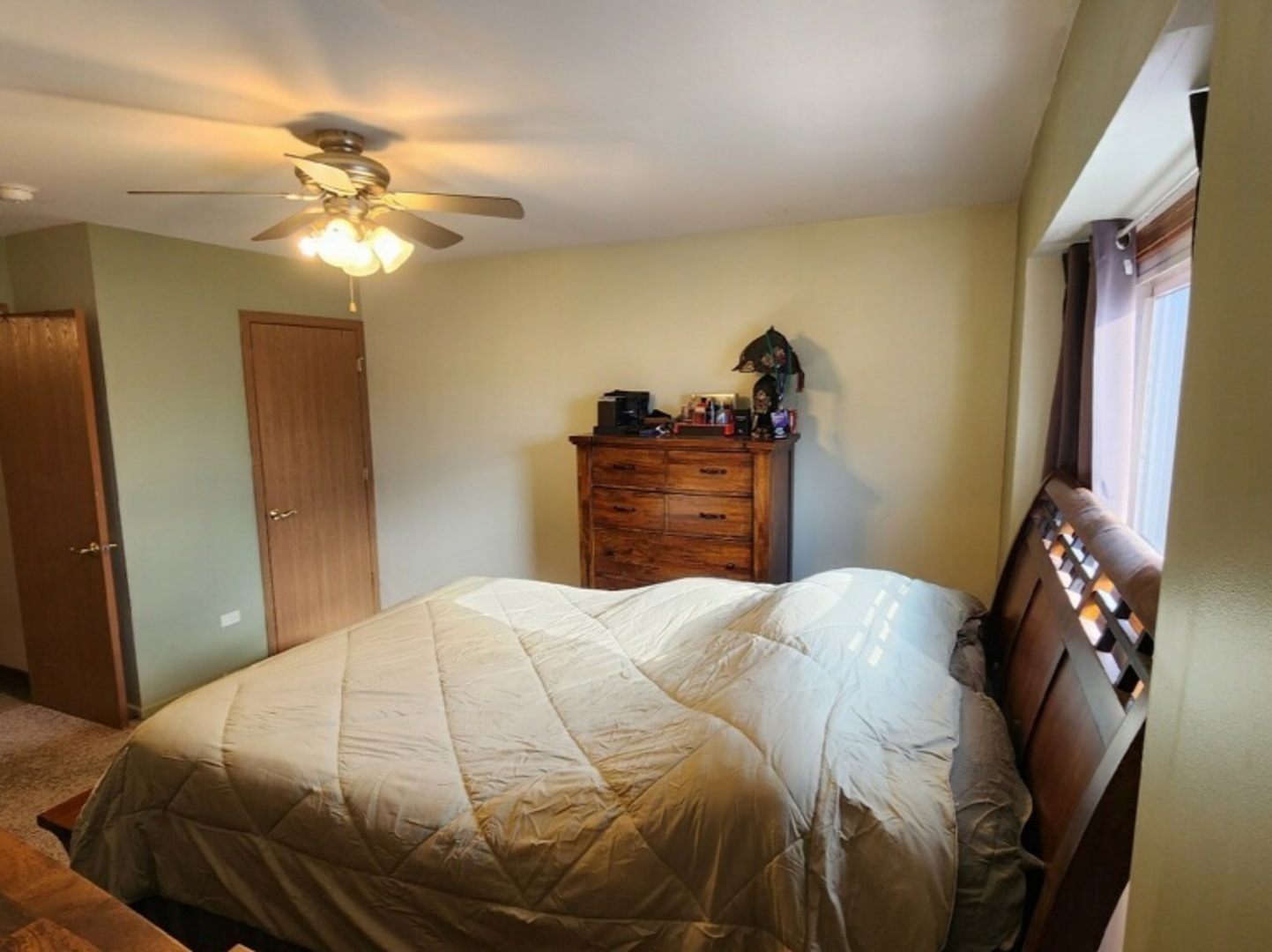 6440 Pamela Lane, Unit 12 Chicago Ridge, IL 60415 - Photo 9 of 15 a bedroom with a bed and a chandelier