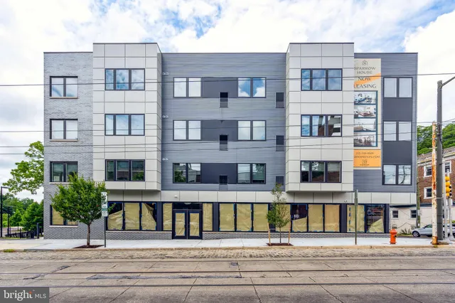 a view of building with yard in front of it