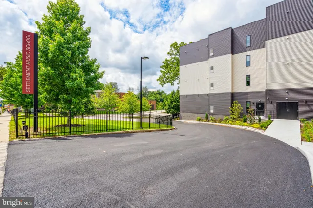 a kitchen with kitchen island granite countertop a refrigerator stove a sink and dishwasher with wooden floor