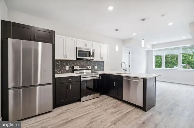 a kitchen with a sink and a refrigerator
