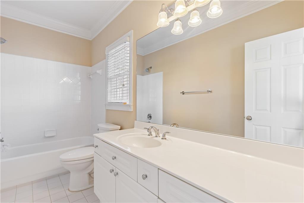 2020 Cockrell Run Northwest Kennesaw, GA 30152 - Photo 40 of 85 a bathroom with a granite countertop sink a toilet and shower