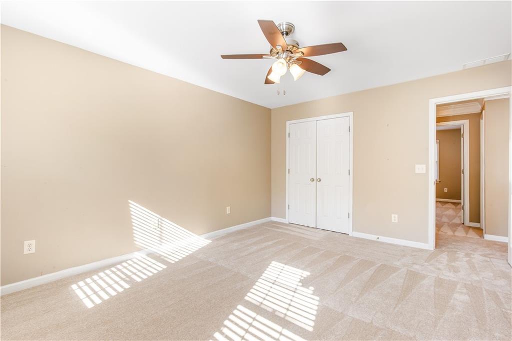 2020 Cockrell Run Northwest Kennesaw, GA 30152 - Photo 56 of 85 a view of a big room with wooden floor and a ceiling fan