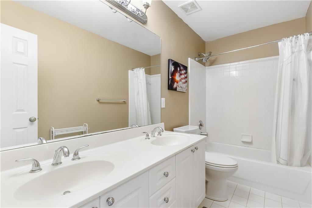 2020 Cockrell Run Northwest Kennesaw, GA 30152 - Photo 57 of 85 a bathroom with a granite countertop sink a toilet and shower