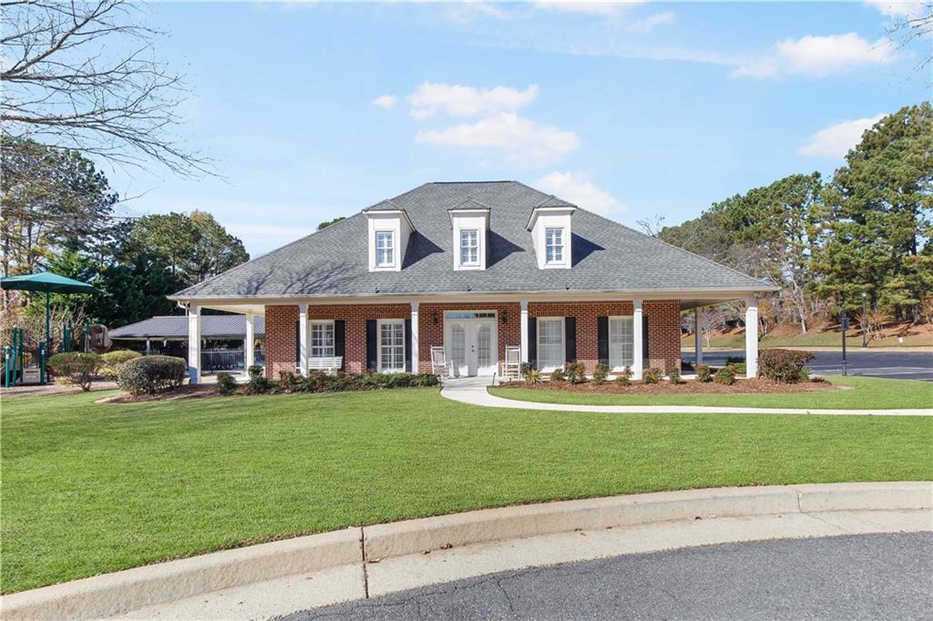 2020 Cockrell Run Northwest Kennesaw, GA 30152 - Photo 75 of 85 a front view of a house with a garden and trees