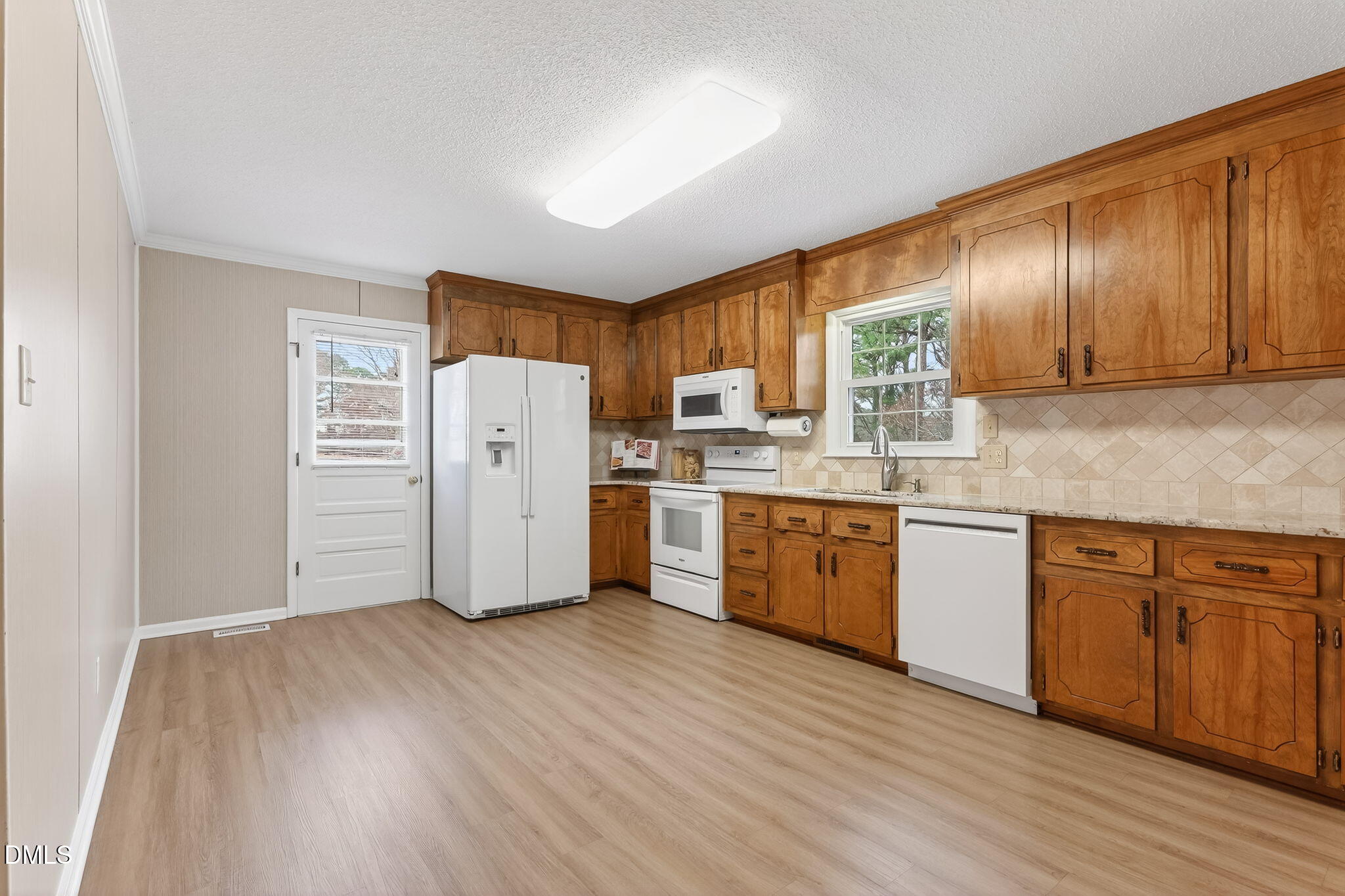 6313 Brack Penny Road Raleigh, NC 27603 - Photo 15 of 41 a kitchen with wooden floors and white appliances