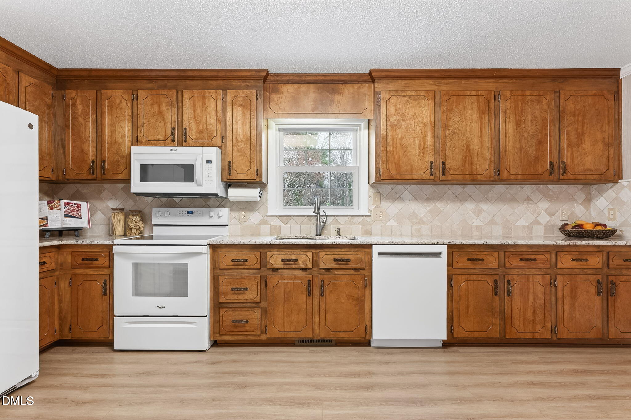 6313 Brack Penny Road Raleigh, NC 27603 - Photo 17 of 41 a kitchen with stainless steel appliances granite countertop a stove a sink dishwasher and a refrigerator with wooden cabinets