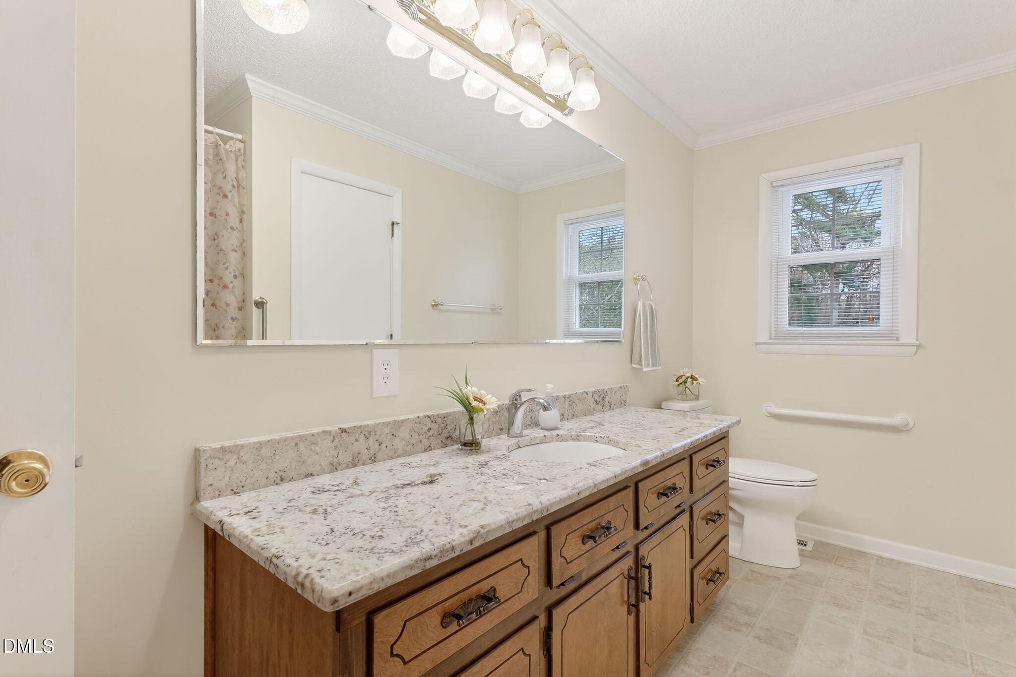 6313 Brack Penny Road Raleigh, NC 27603 - Photo 24 of 41 a bathroom with a granite countertop sink and a mirror