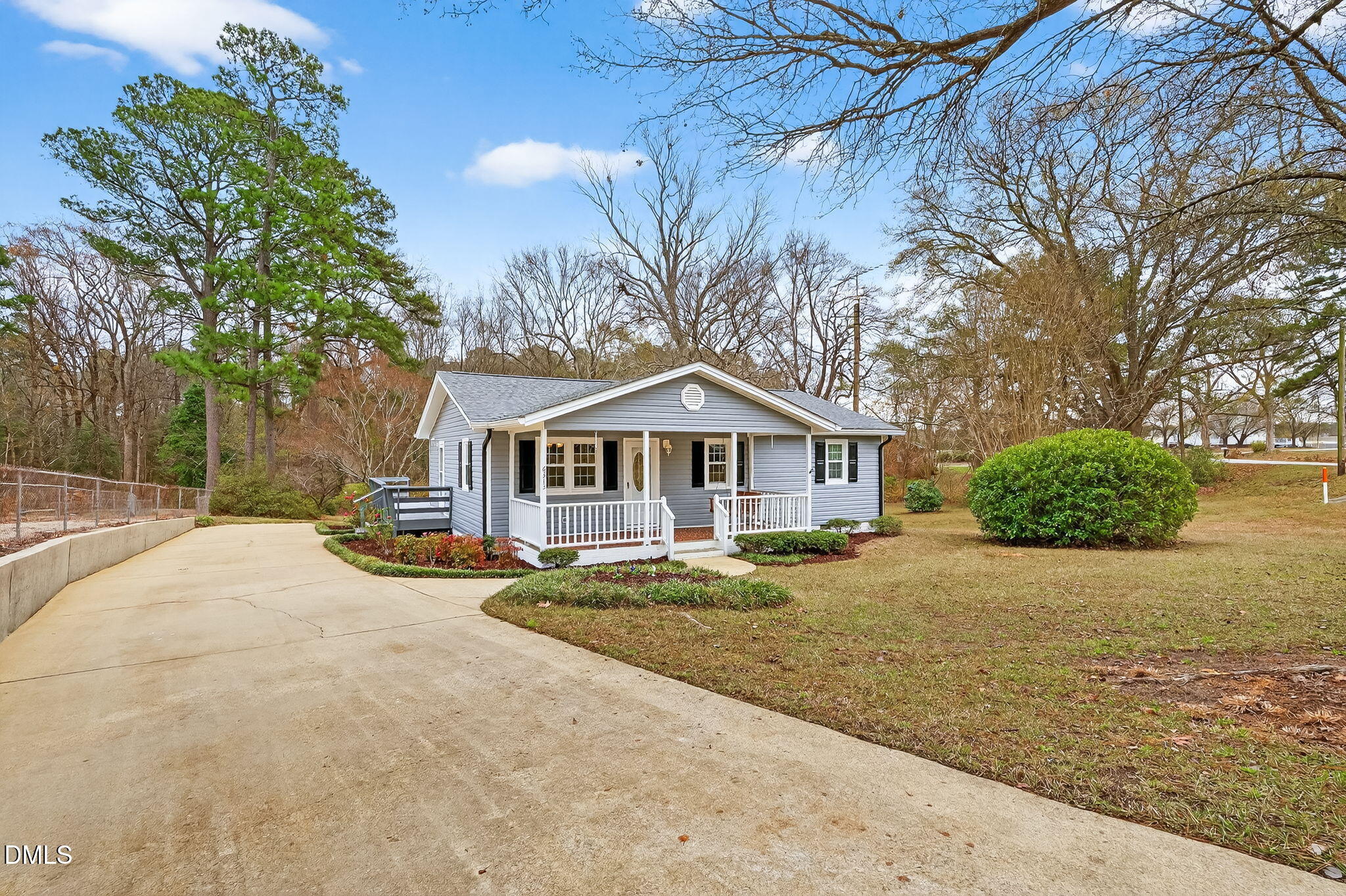 6313 Brack Penny Road Raleigh, NC 27603 - Photo 4 of 41 a front view of a house with a yard and trees