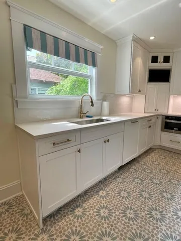 a spacious bathroom with a sink a large mirror and a window