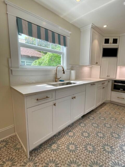 415 Upland Road West Palm Beach, FL 33401 - Photo 11 of 29 a spacious bathroom with a sink a large mirror and a window