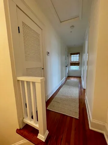 an entryway with wooden floor and staircase