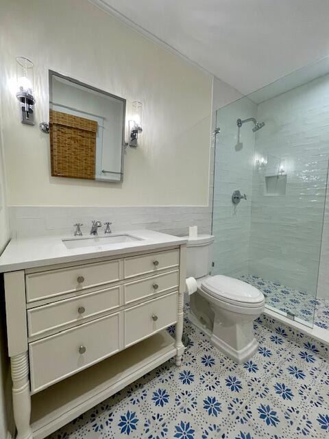 415 Upland Road West Palm Beach, FL 33401 - Photo 20 of 29 a bathroom with a toilet a sink a mirror a shower a vanity and window