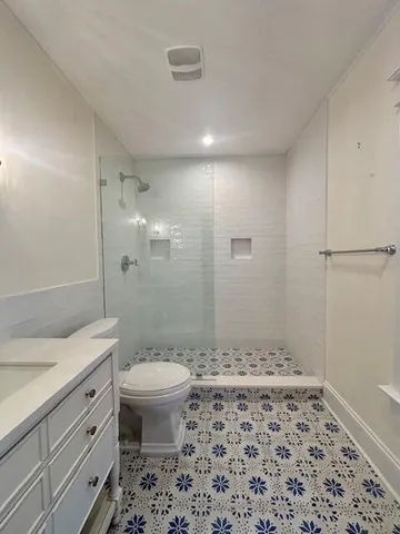 a bathroom with a sink toilet and shower