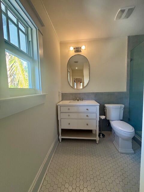 415 Upland Road West Palm Beach, FL 33401 - Photo 25 of 29 a bathroom with a sink mirror vanity and toilet