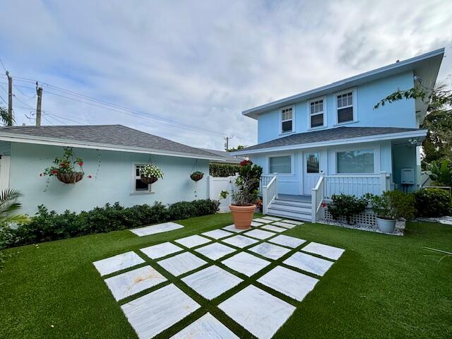 415 Upland Road West Palm Beach, FL 33401 - Photo 27 of 29 a front view of a house with garden