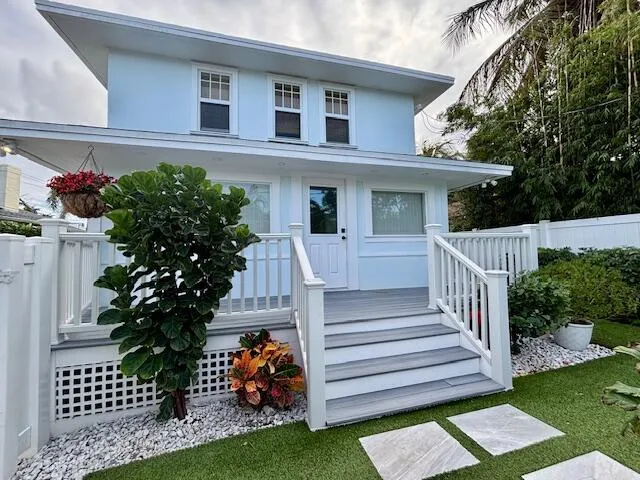 a view of a house with a yard and a garden