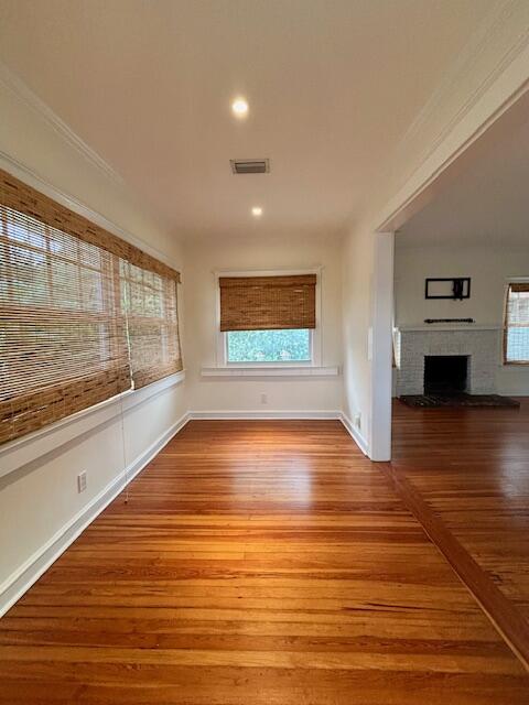 415 Upland Road West Palm Beach, FL 33401 - Photo 3 of 29 a view of an empty room with wooden floor and a window