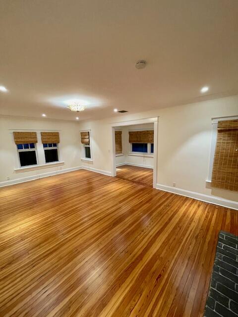 415 Upland Road West Palm Beach, FL 33401 - Photo 5 of 29 a view of an empty room with wooden floor and a window