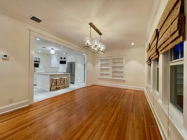 415 Upland Road West Palm Beach, FL 33401 - Photo 7 of 29 a view of an empty room with wooden floor and a window