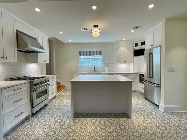 a kitchen with stainless steel appliances a sink stove and refrigerator