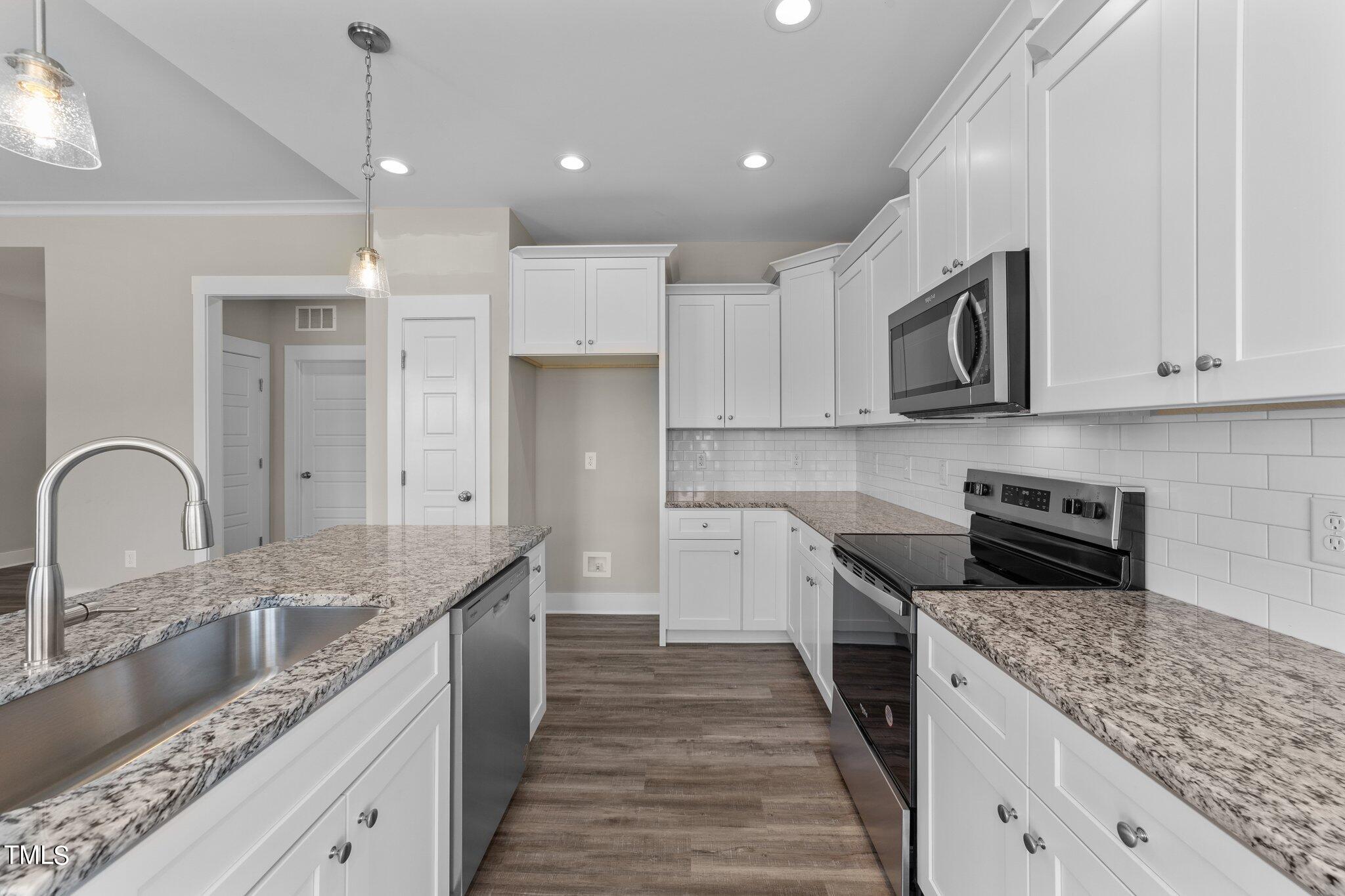 282 Fields Road Pikeville, NC 27863 - Photo 14 of 40 a kitchen with kitchen island granite countertop a sink stainless steel appliances and cabinets