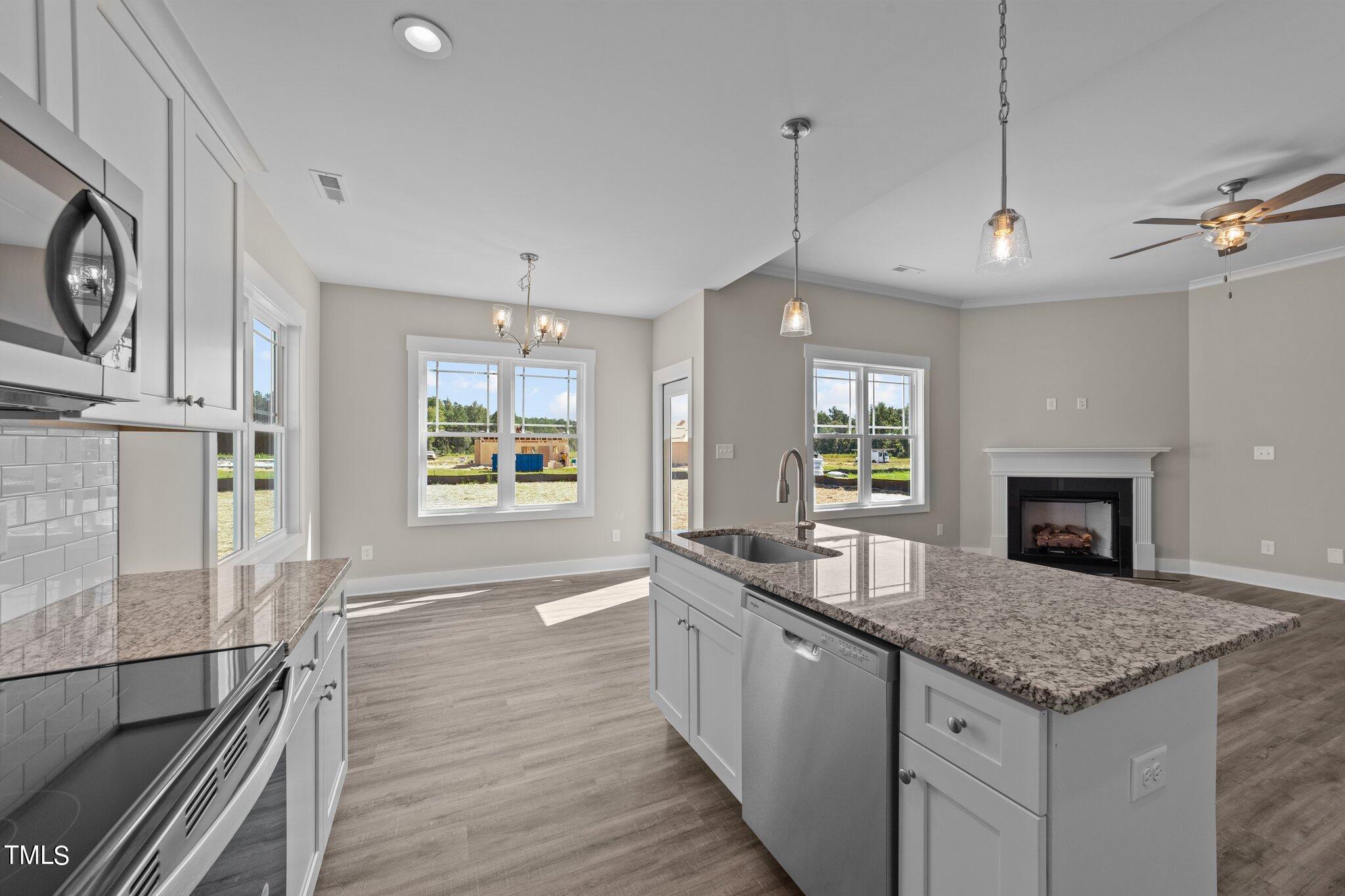 282 Fields Road Pikeville, NC 27863 - Photo 16 of 40 a large kitchen with granite countertop a stove and a sink