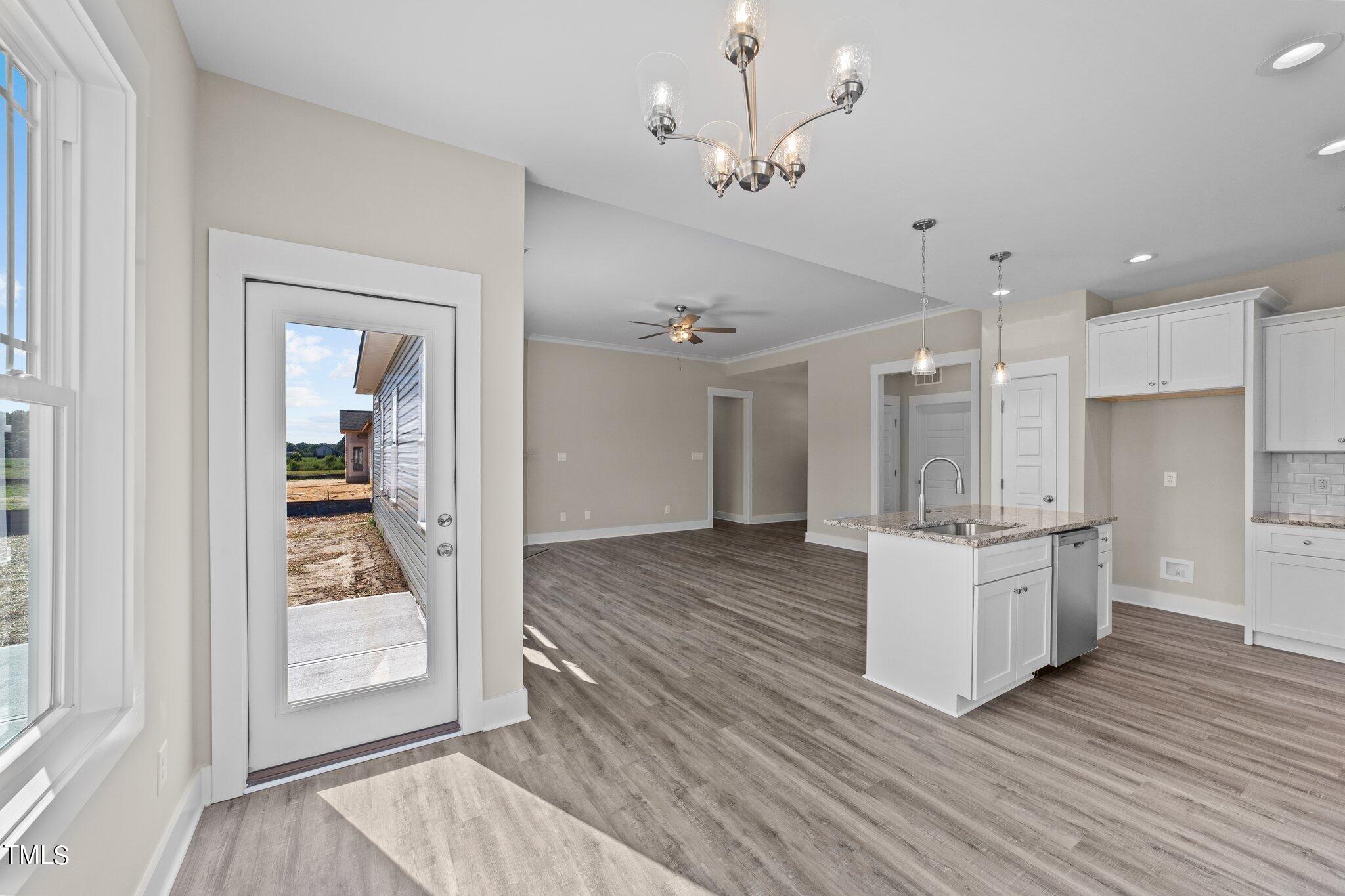 282 Fields Road Pikeville, NC 27863 - Photo 20 of 40 a open kitchen with white cabinets and wooden floor