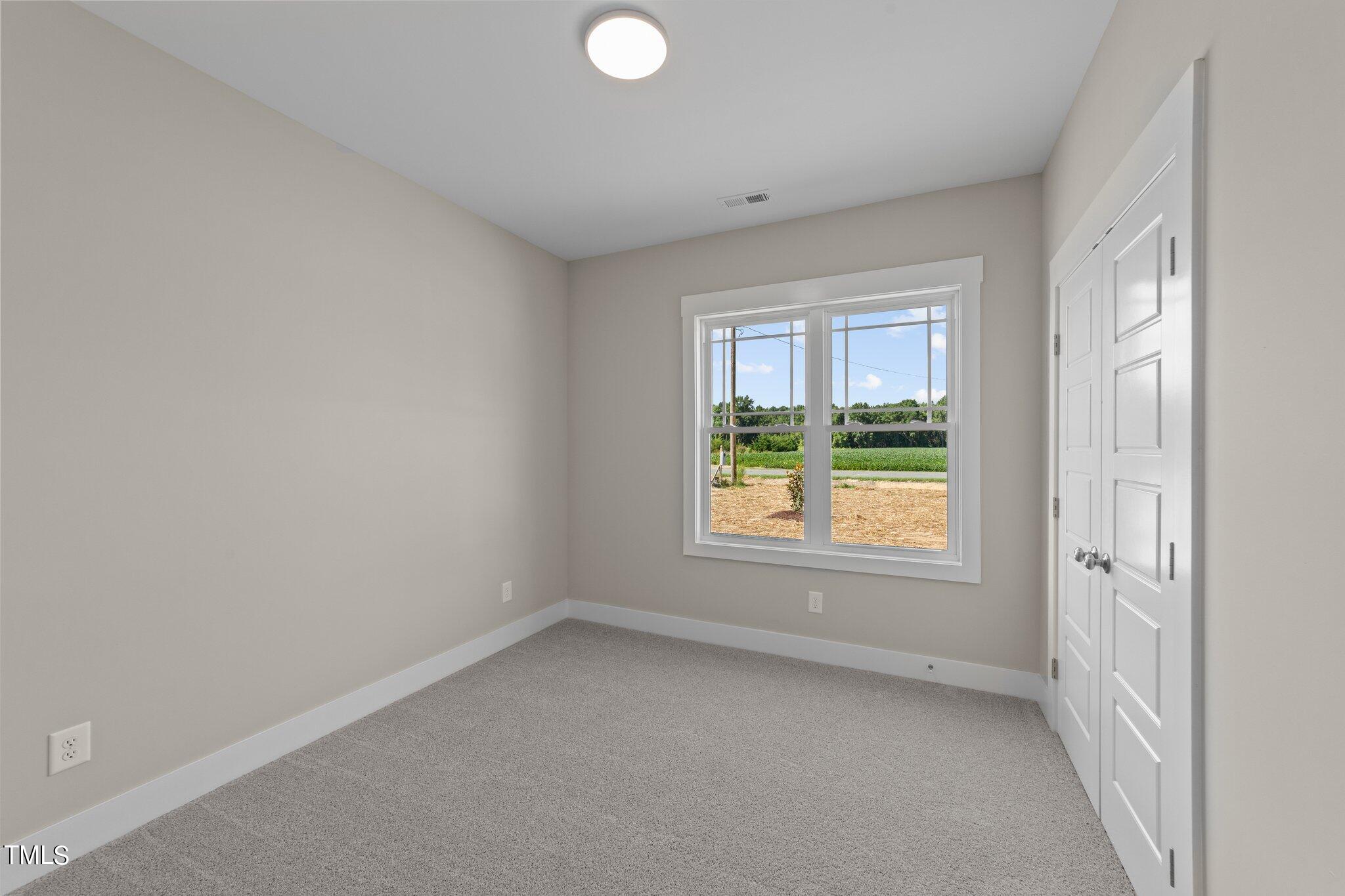 282 Fields Road Pikeville, NC 27863 - Photo 25 of 40 an empty room with a window