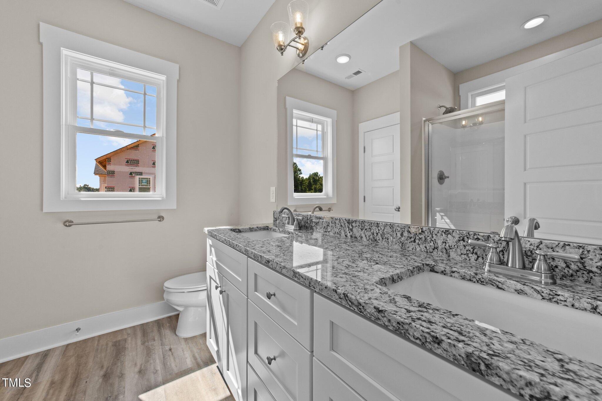 282 Fields Road Pikeville, NC 27863 - Photo 30 of 40 a bathroom with a granite countertop double vanity sink a mirror and a