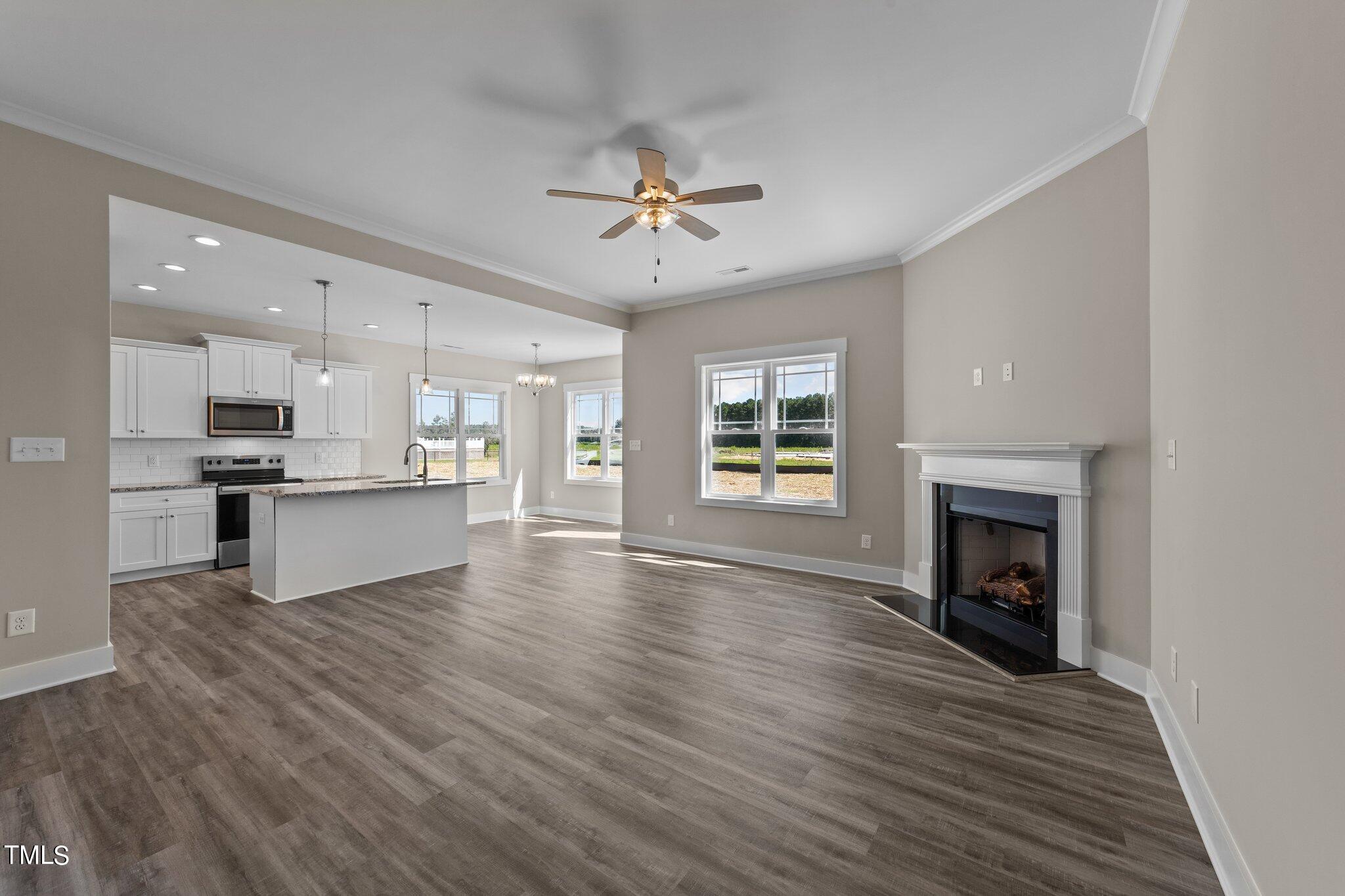 282 Fields Road Pikeville, NC 27863 - Photo 5 of 40 a view of kitchen with livingroom and fireplace wooden floor
