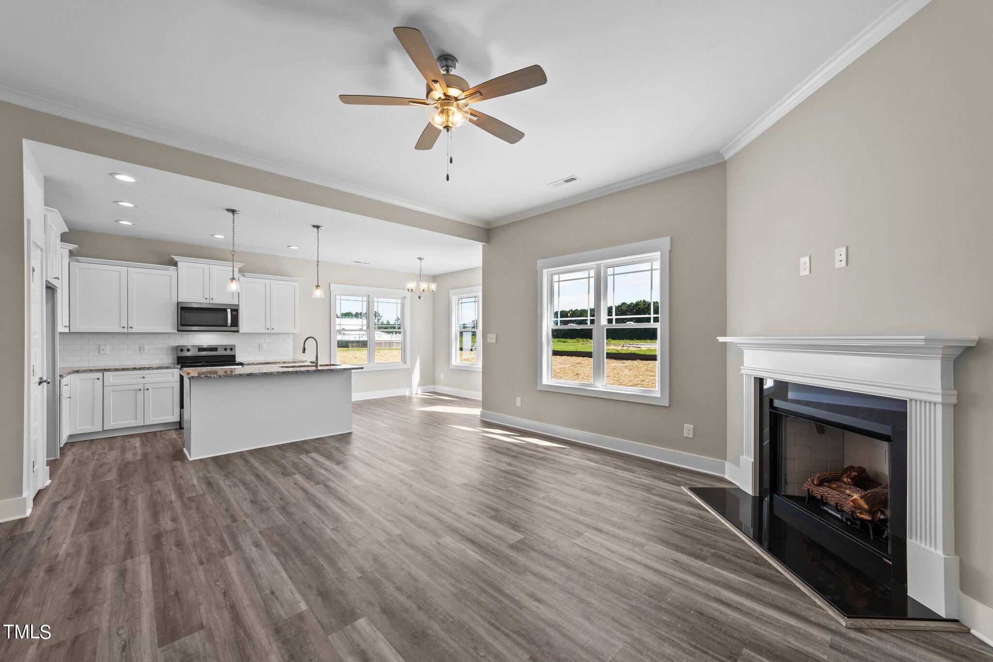 282 Fields Road Pikeville, NC 27863 - Photo 6 of 40 a view of kitchen with cabinets and fireplace