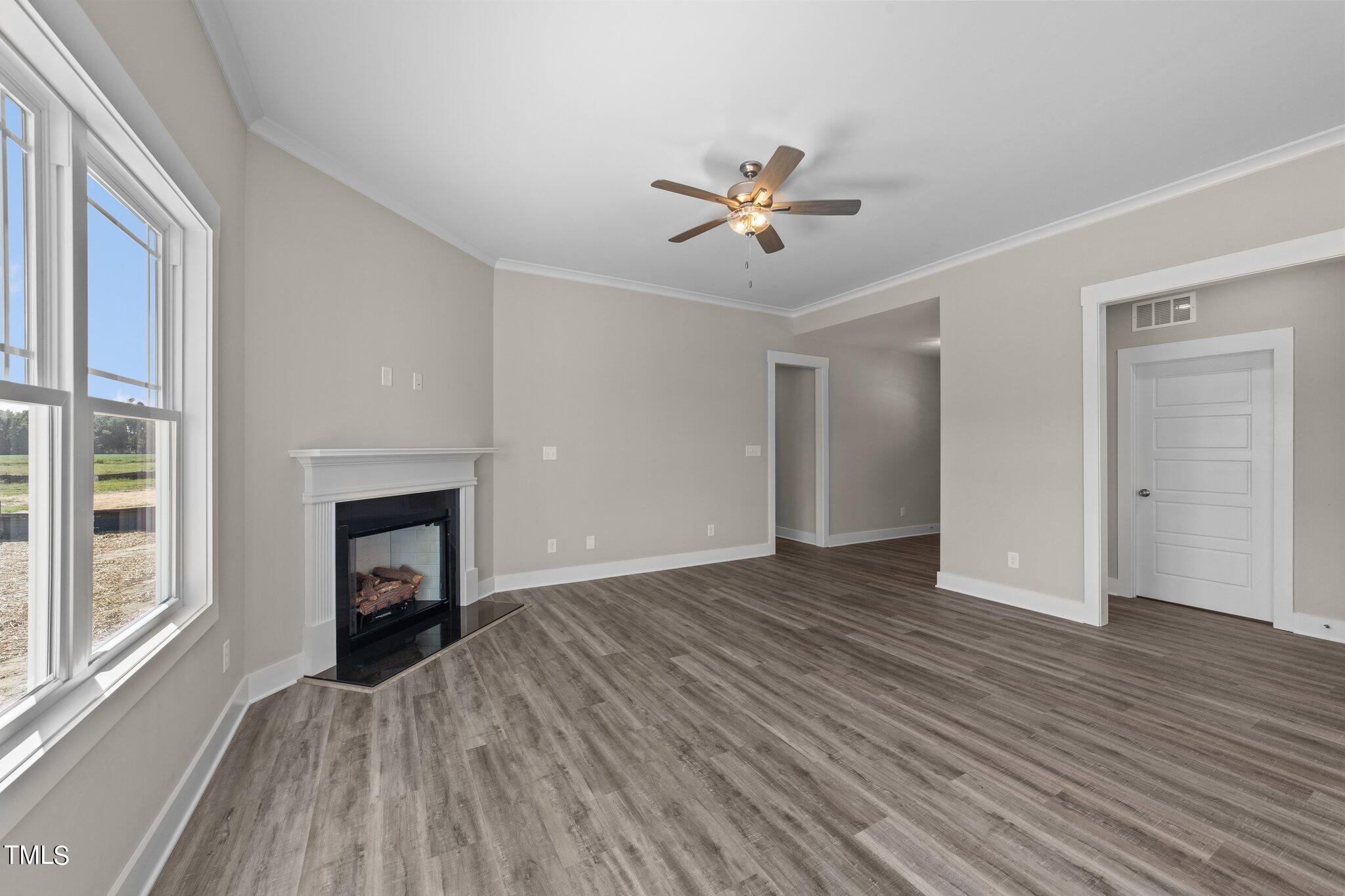 282 Fields Road Pikeville, NC 27863 - Photo 7 of 40 a view of empty room with wooden floor and fireplace