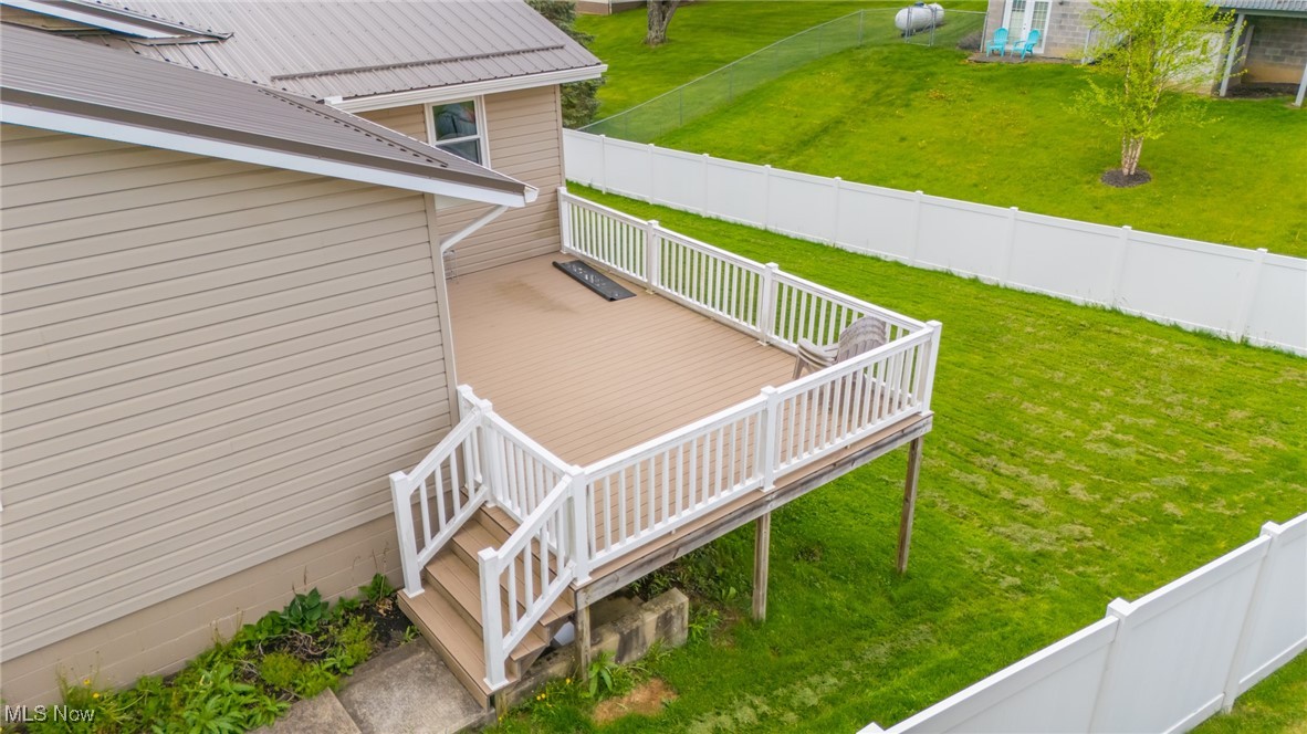 53350 High Ridge Road Bridgeport, OH 43912 - Photo 28 of 37 Wooden deck with a fenced backyard and a lawn