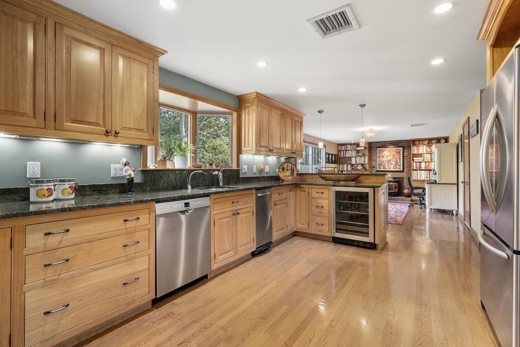 14 Independence Drive Brookline, MA 02467 - Photo 11 of 35 a kitchen with stainless steel appliances kitchen island granite countertop a stove a sink and a refrigerator