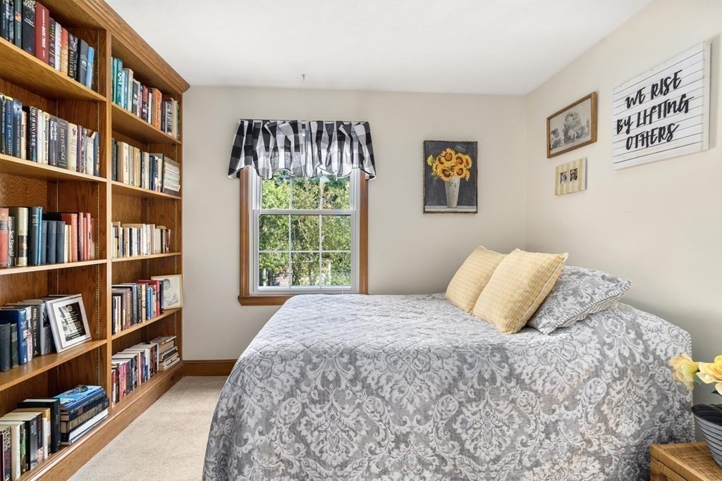 14 Independence Drive Brookline, MA 02467 - Photo 19 of 35 a bedroom with a bed a book shelf and a window