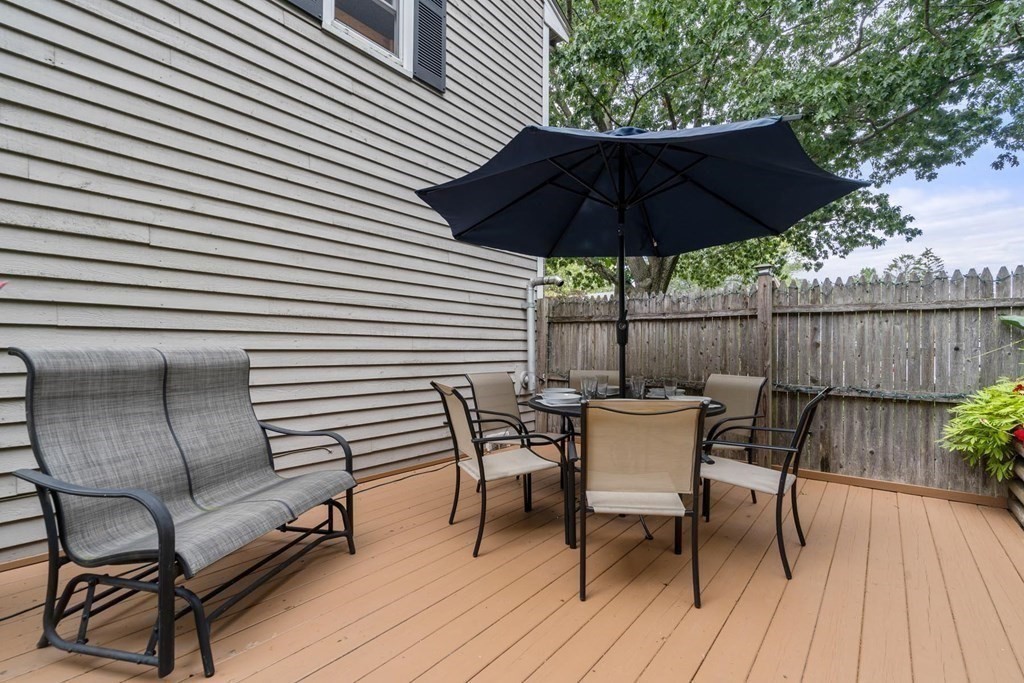 14 Independence Drive Brookline, MA 02467 - Photo 24 of 35 a patio with wooden floor a yard a table and chairs
