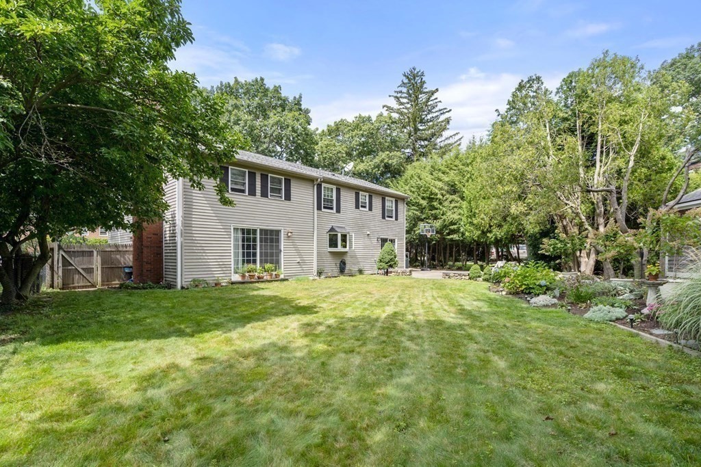 14 Independence Drive Brookline, MA 02467 - Photo 29 of 35 a house that is sitting in the grass with large trees and plants