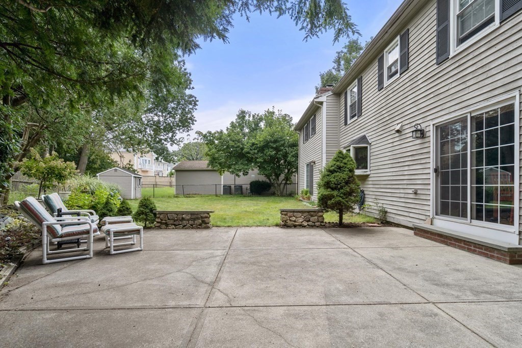 14 Independence Drive Brookline, MA 02467 - Photo 33 of 35 a view of a chair and tables in the back yard of the house
