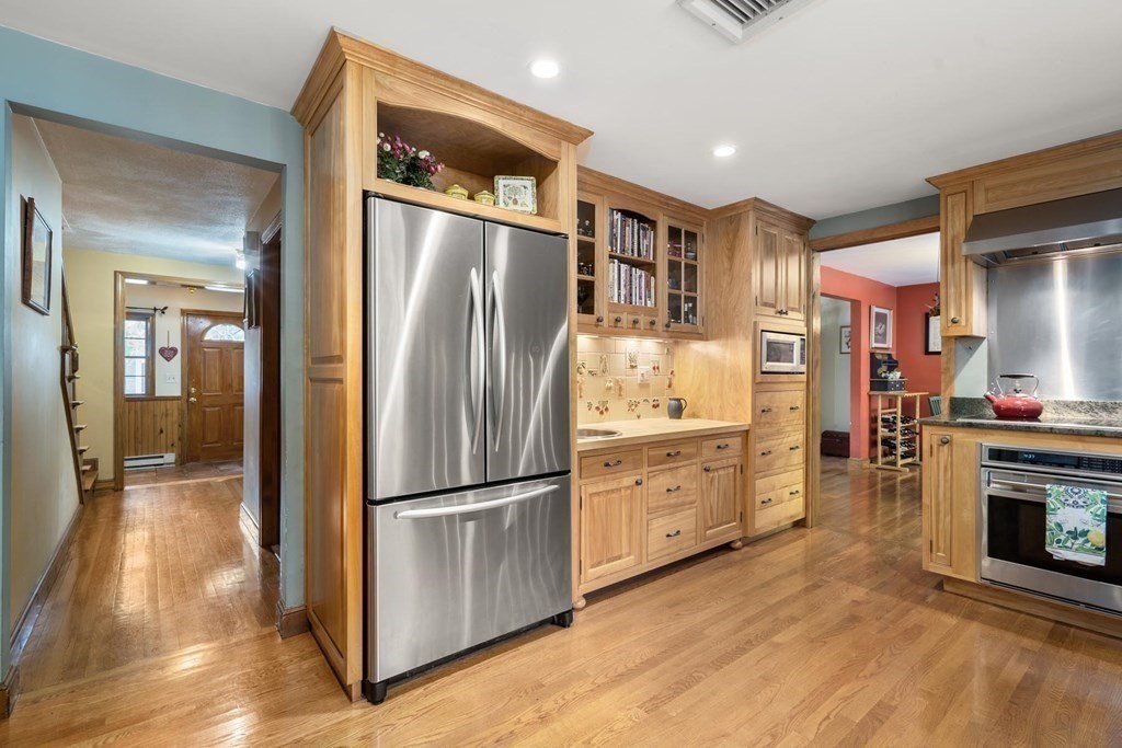14 Independence Drive Brookline, MA 02467 - Photo 9 of 35 a kitchen with granite countertop stainless steel appliances a refrigerator and a stove top oven