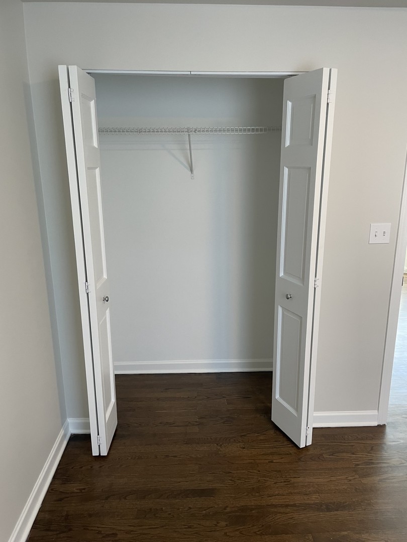 7318 North Honore Street, Unit 403 Chicago, IL 60626 - Photo 11 of 15 an empty room with wooden floor and entrance