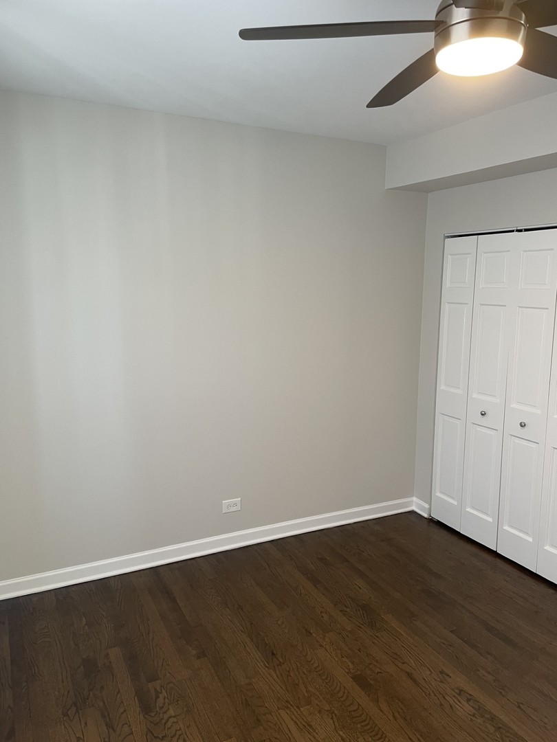 7318 North Honore Street, Unit 403 Chicago, IL 60626 - Photo 9 of 15 a view of an empty room with wooden floor