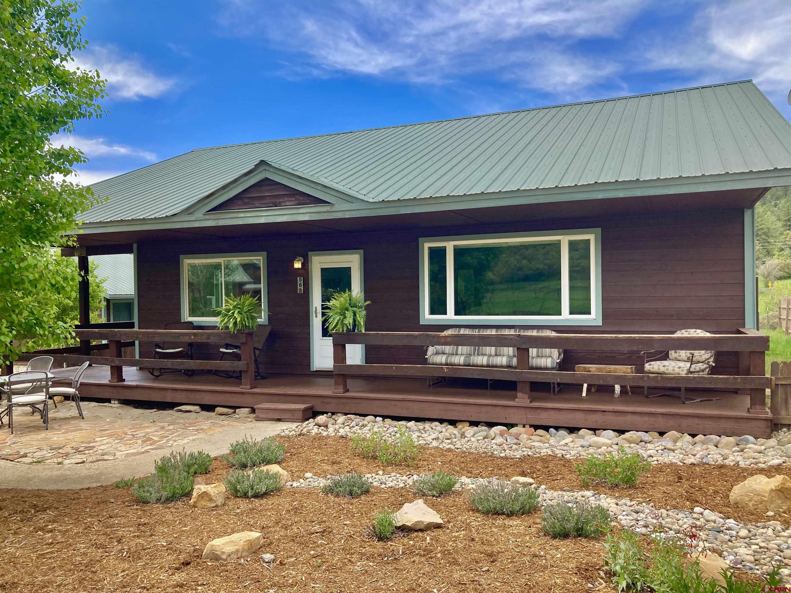 56 Bad Mule Road Durango, CO 81301 - Photo 1 of 35 a front view of a house with a yard