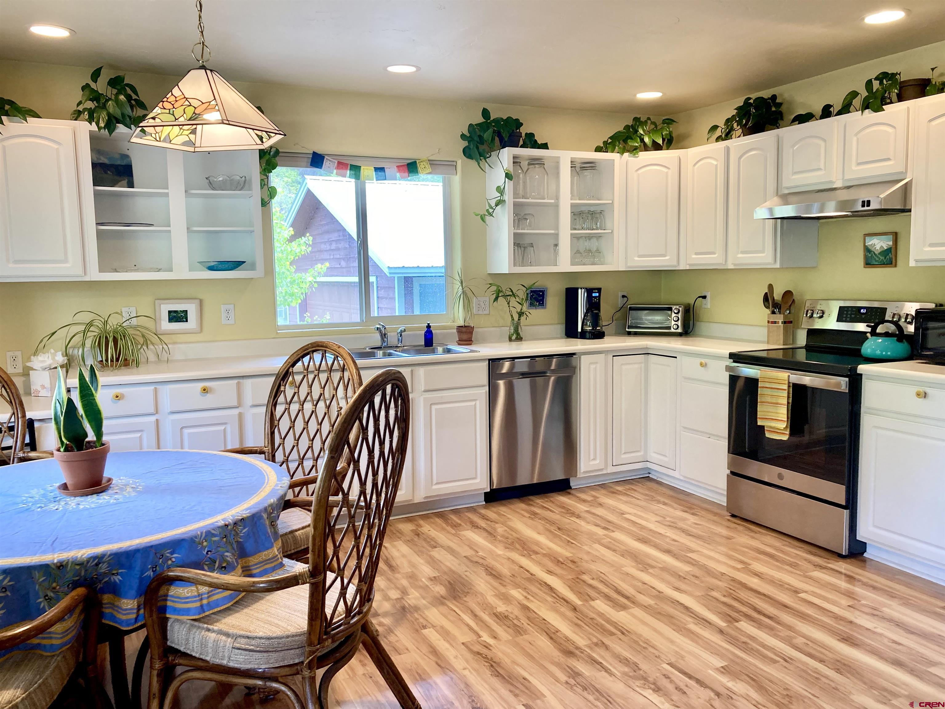56 Bad Mule Road Durango, CO 81301 - Photo 11 of 35 a kitchen with a table chairs microwave and cabinets