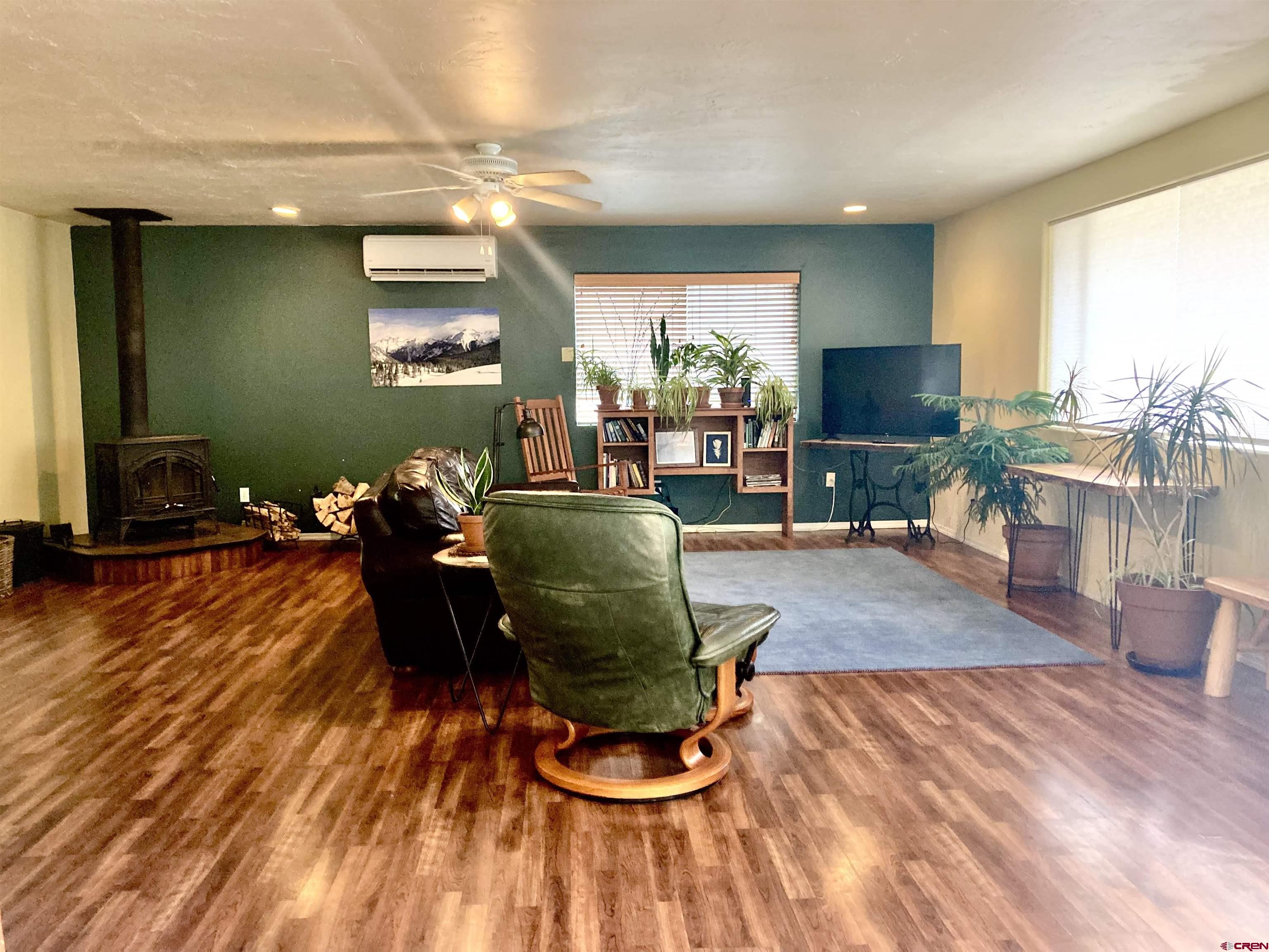 56 Bad Mule Road Durango, CO 81301 - Photo 16 of 35 a living room with furniture a flat screen tv and a large window